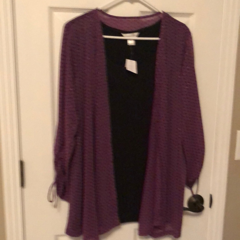Women’s tunic blouse with flyaway attached to black tunic.